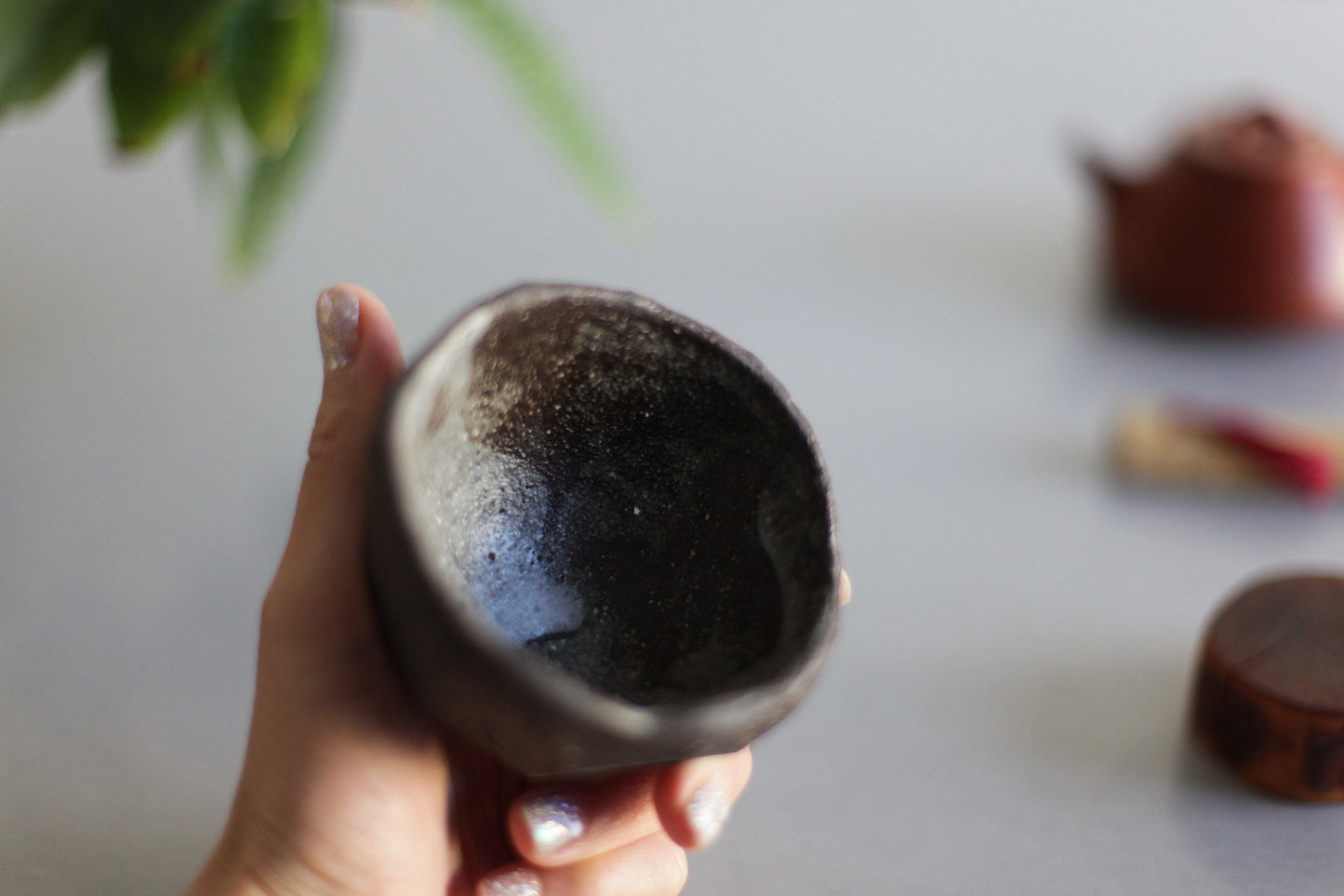 Dark brown faceted tea bowl