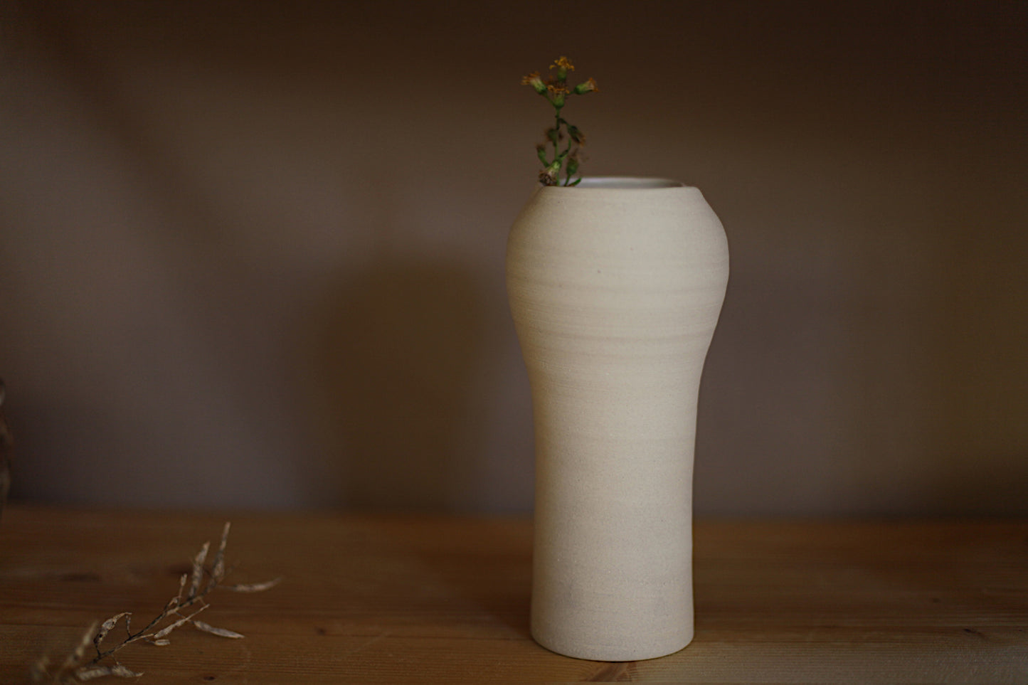 Off white vessel with wide altered opening